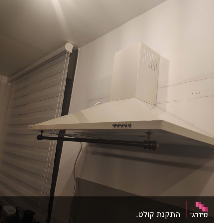 קולט אדים לבן מותקן על קיר במטבח